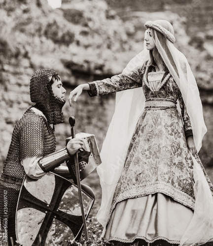 Knight and medieva lady at outdoor. Image in black and white color style photo
