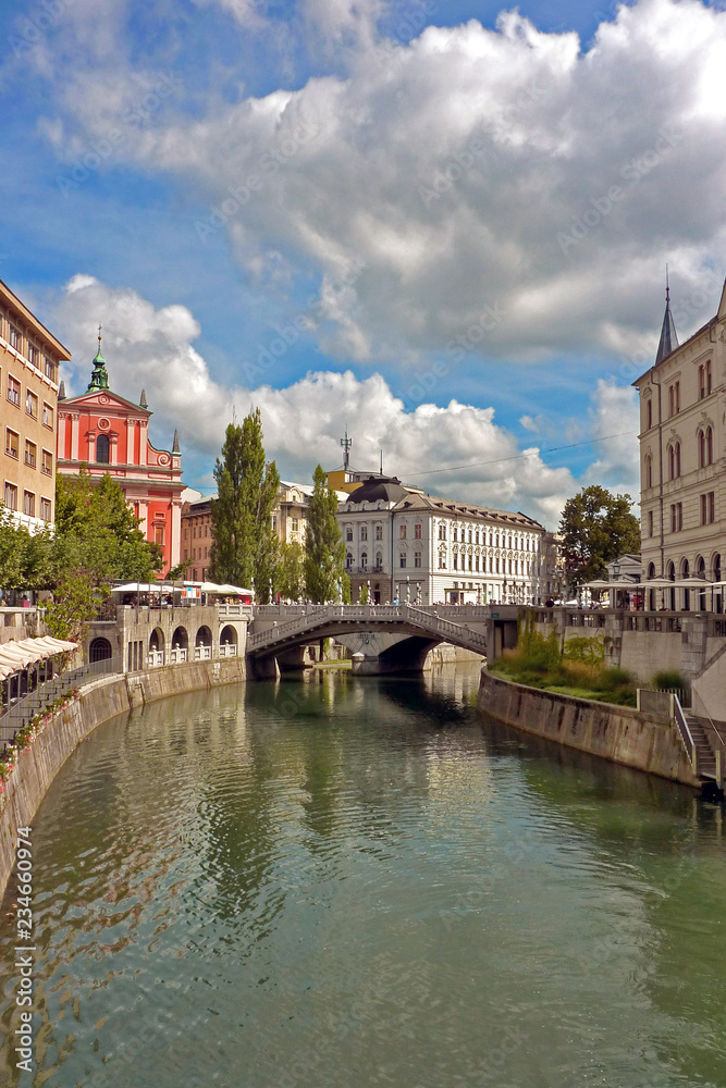 Ljubljana seen through the River Ljubljanica, with the Triple Bridge in the distance