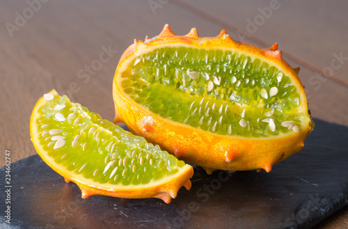 Sliced Fruit Kivano melon on wooden background. Close up. photo