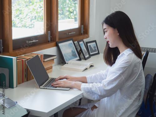 young asian woman working with computer in room