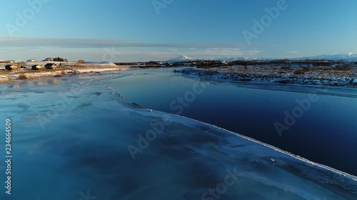 Icy river, blue skies and mountain