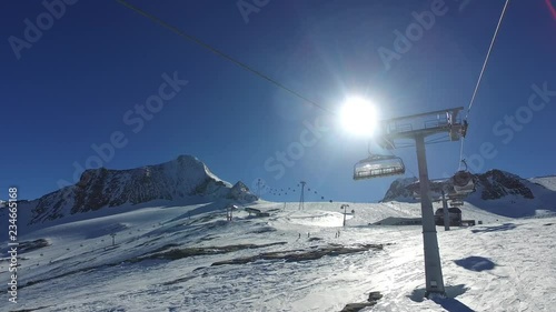 Riding up ski gondola sunny day