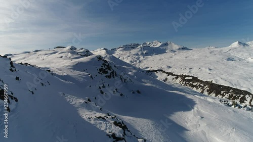 Sunny day on snow covered mountain