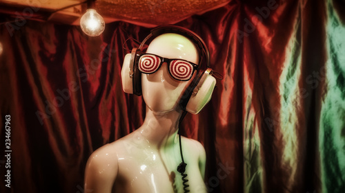 Hypnotic glasses and vintage headphones on a female mannequin.