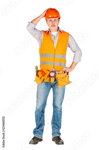 Portrait of a male builder in a helmet looking at camera over white wall background. repair, construction, building, people and maintenance concept.