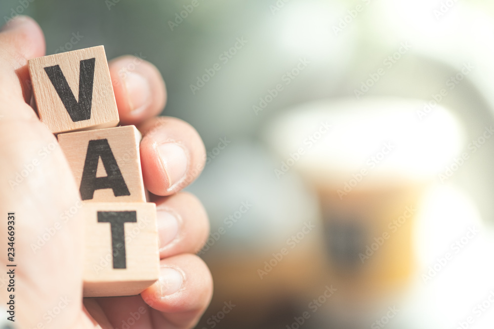 Wooden letter blocks the word tax on hand. Wooden letter blocks the word tax on hand.