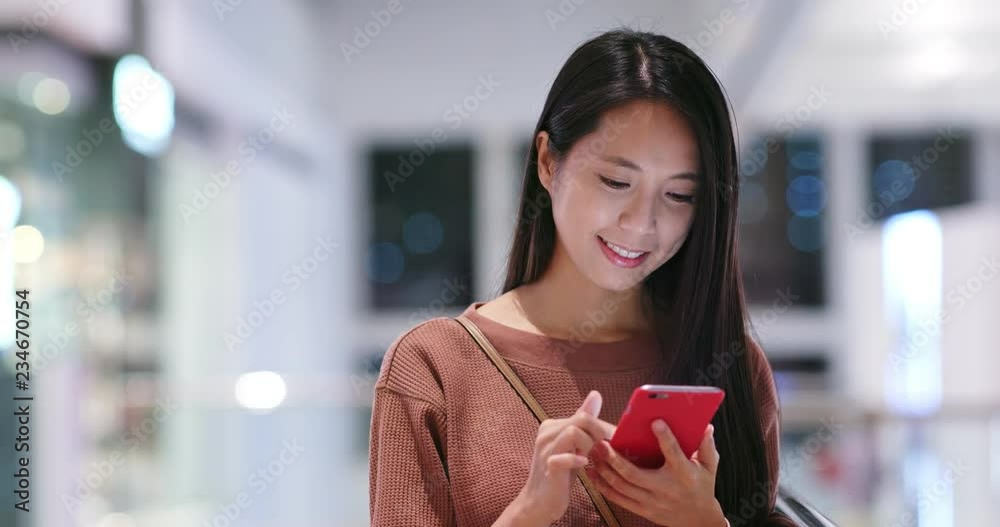 Woman read on mobile phone inside shopping mall