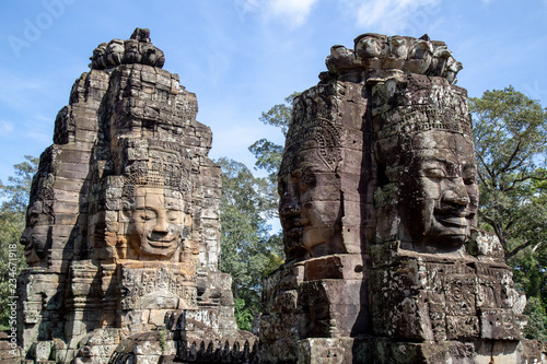 Ancient temple name Bayon with stone faces in Angkor Thom, Siem Reap, Cambodia. Bayon's most distinctive feature is the multitude of serene and smiling stone faces on the many towers. © chayakorn