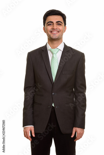 Young happy Persian businessman looking at camera