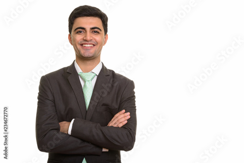 Young handsome Persian businessman looking at camera while smiling