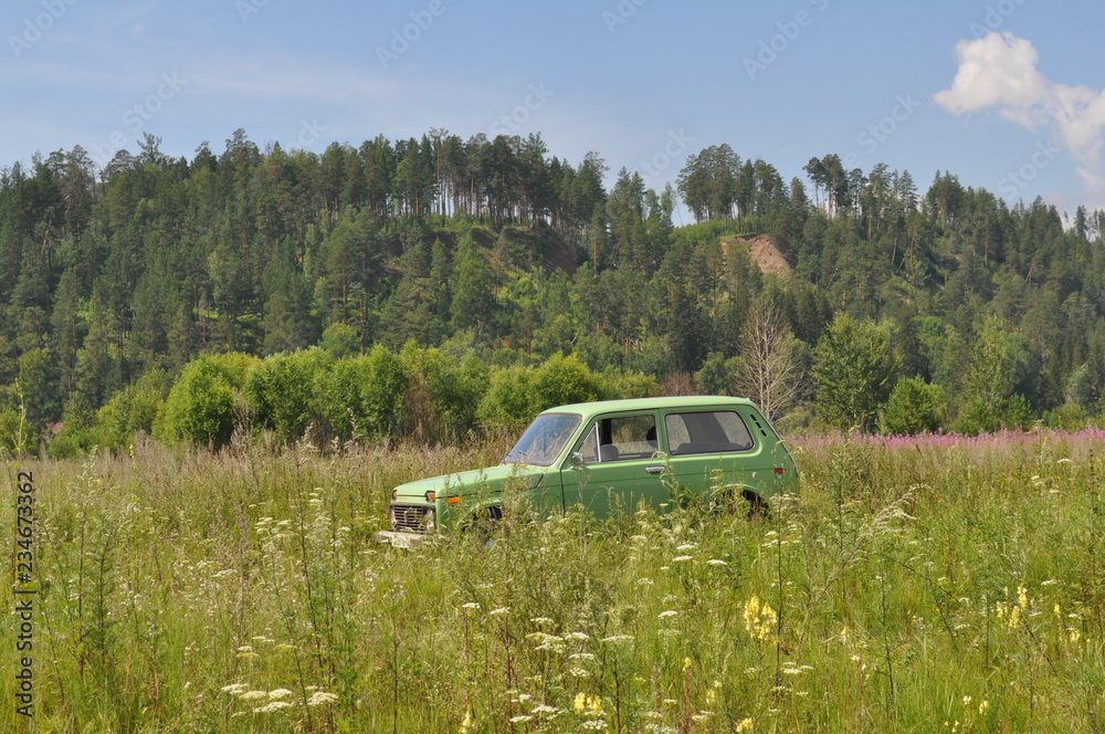 Car Lada Niva in the field. Russian SUV in the forest. Car Lada Niva in the field. Russian SUV in the forest.