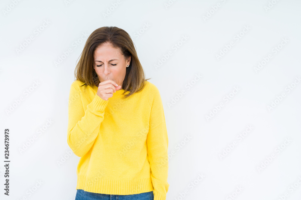 Beautiful middle age woman wearing yellow sweater over isolated background feeling unwell and coughing as symptom for cold or bronchitis. Healthcare concept. Beautiful middle age woman wearing yellow sweater over isolated background feeling unwell and coughing as symptom for cold or bronchitis. Healthcare concept.