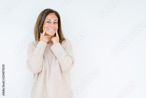 Beautiful middle age woman over isolated background Smiling with open mouth, fingers pointing and forcing cheerful smile
