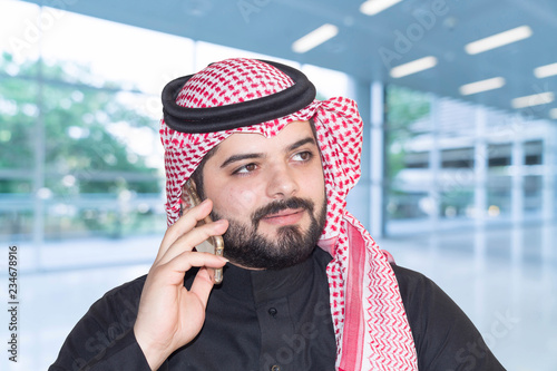 Saudi Arabian man profile, wears traditional clothes photo