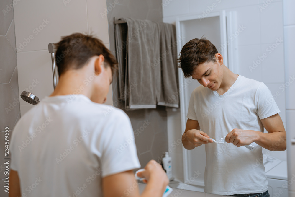 Obraz premium putting tooth paste on tooth brush.