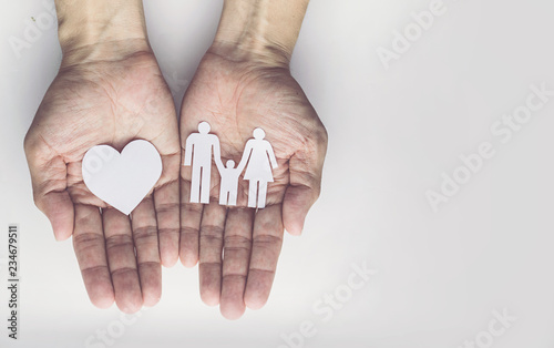 Old man hands holding small model family , concept family