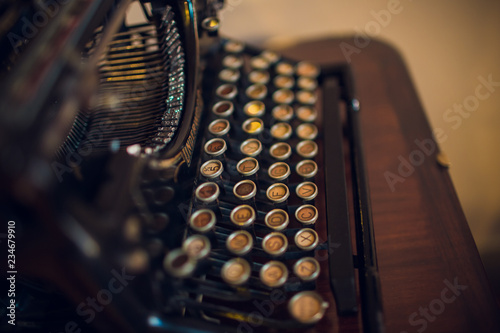 Obraz na plátně Old typewriter on wood on a blue background.