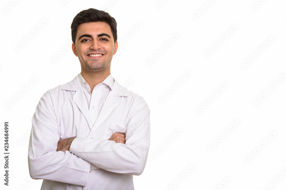 Young happy Persian man doctor smiling with arms crossed Young happy Persian man doctor smiling with arms crossed