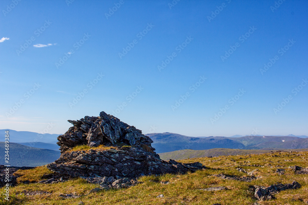 Nature of the Northern Urals. Stones and mountain plateaus against the blue sky.