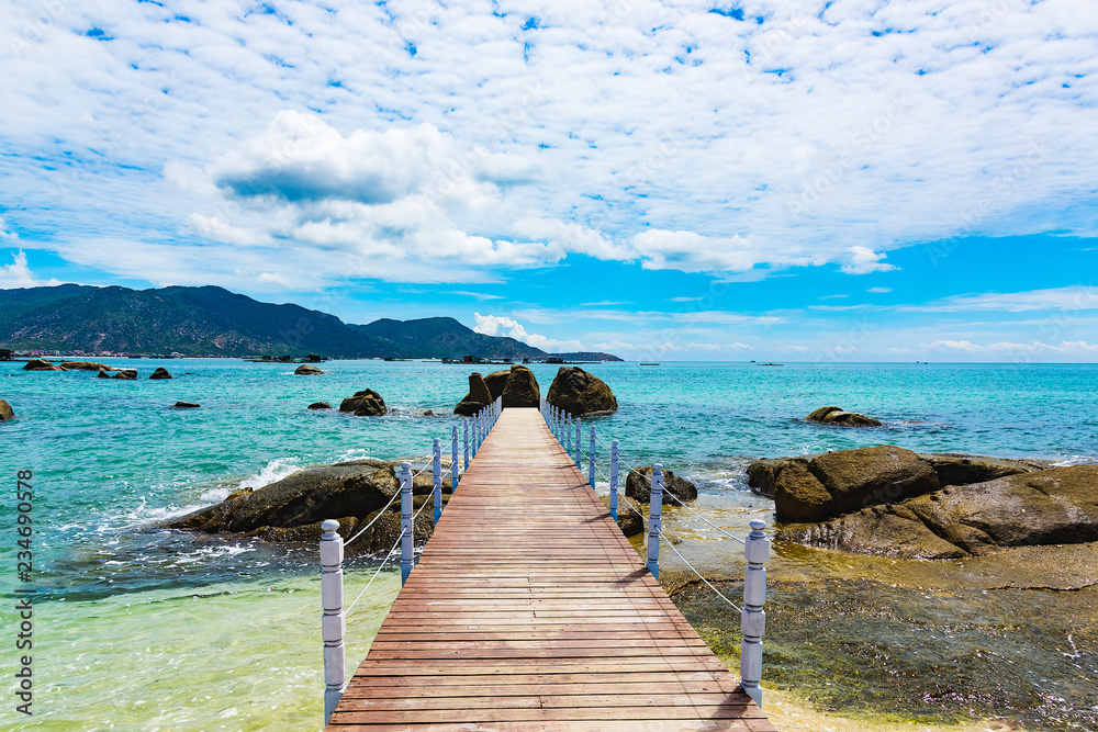 Fototapeta premium wooden bridge juts out into of the sea