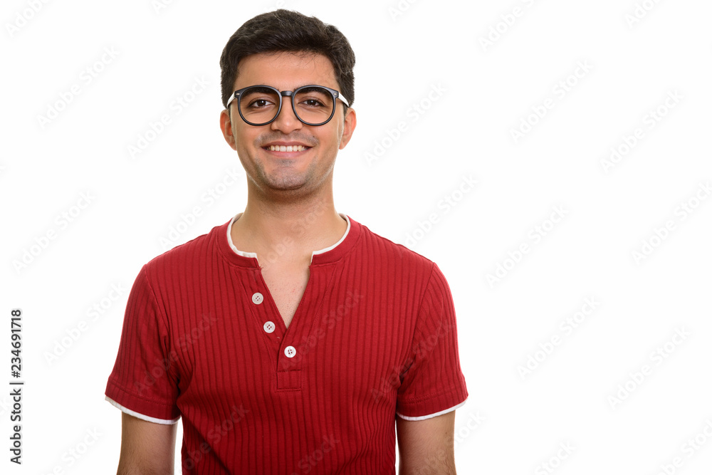 Young happy Persian man smiling and looking at camera Young happy Persian man smiling and looking at camera