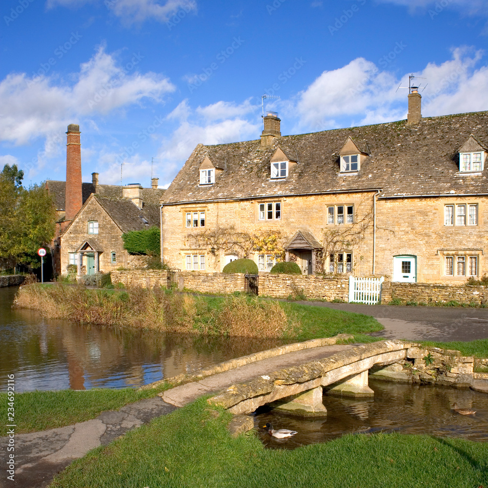 England, Gloucestershire, Cotswolds, idyllic riverside cotswold stone cottages at Lower Slaughter in autumn sunshine
