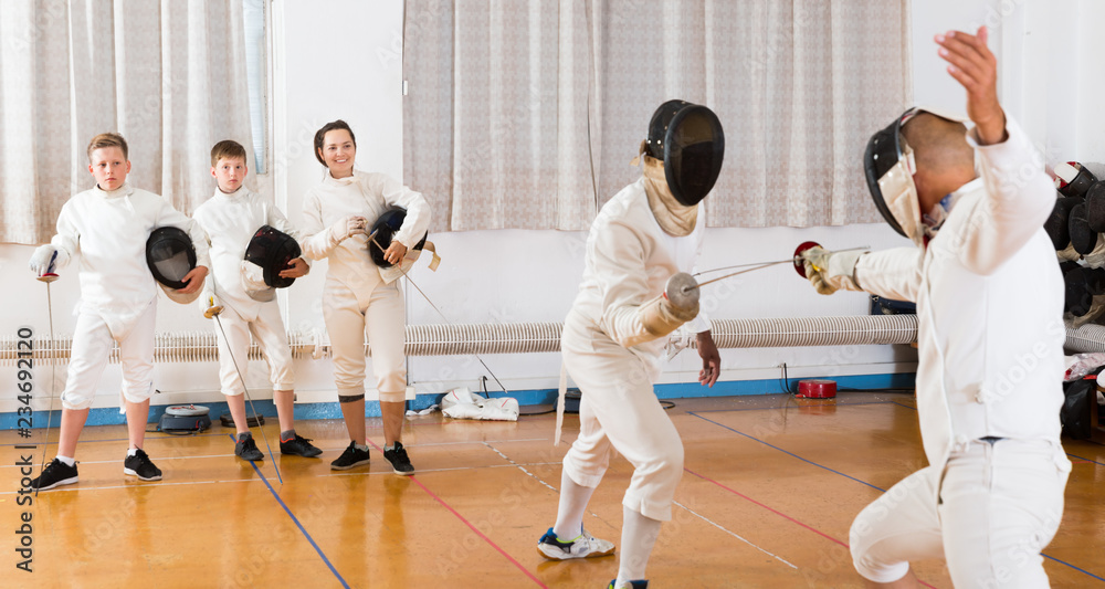Two fencing instructors showing effective techniques