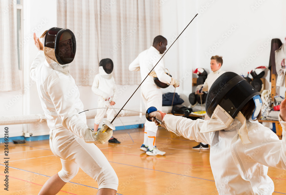 Fototapeta premium Active group practicing fencing techniques