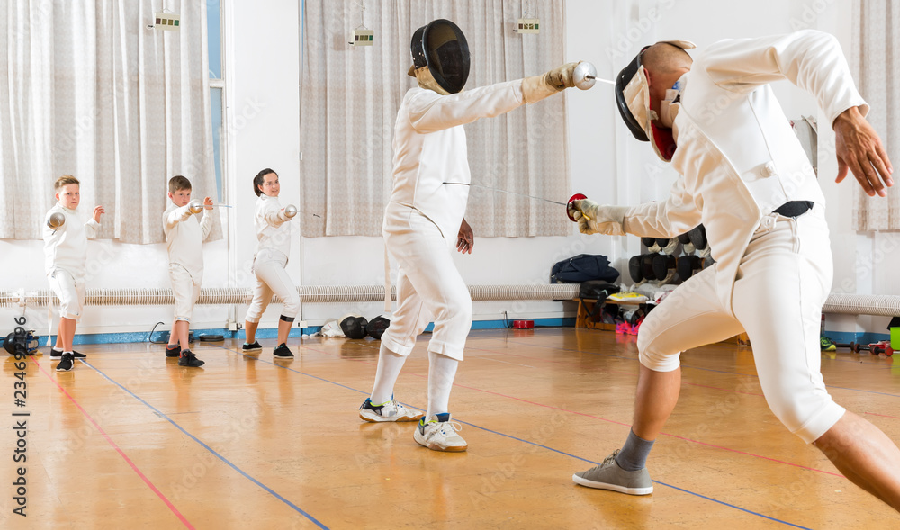 growns and teens athletes at fencing workout