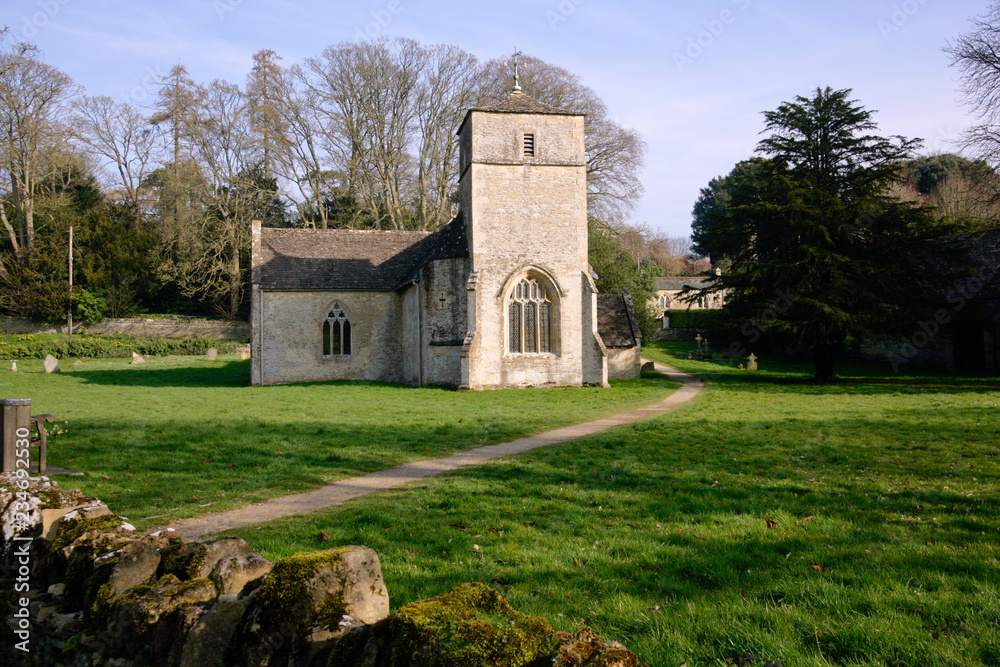 Picturesque village church at Eastleach Martin in spring sunshine, Gloucestershire, UK