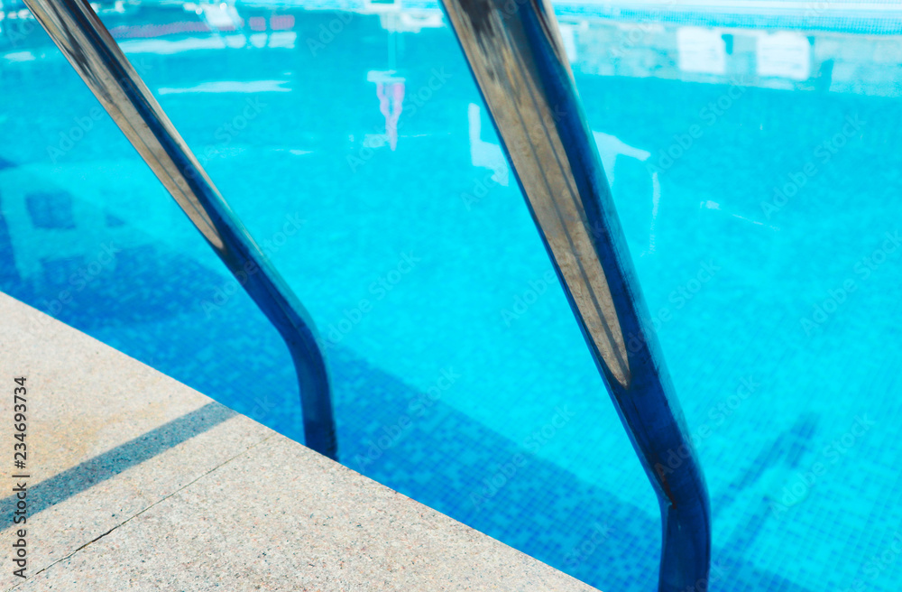 Abstract swimming pool metal staircase in the water. 
