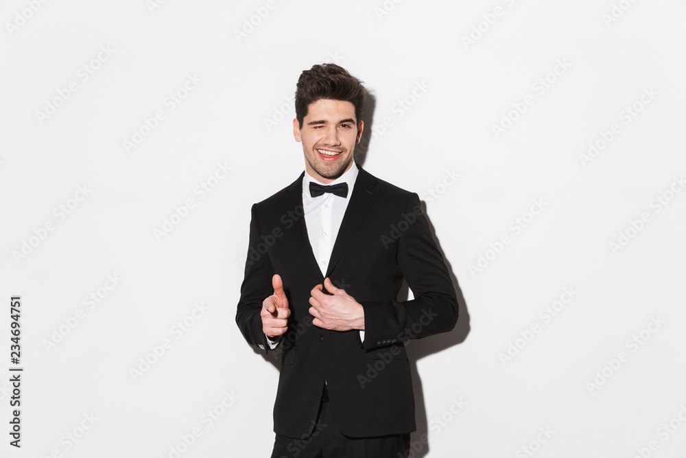 Portrait of a smiling young man wearing black suit Portrait of a smiling young man wearing black suit