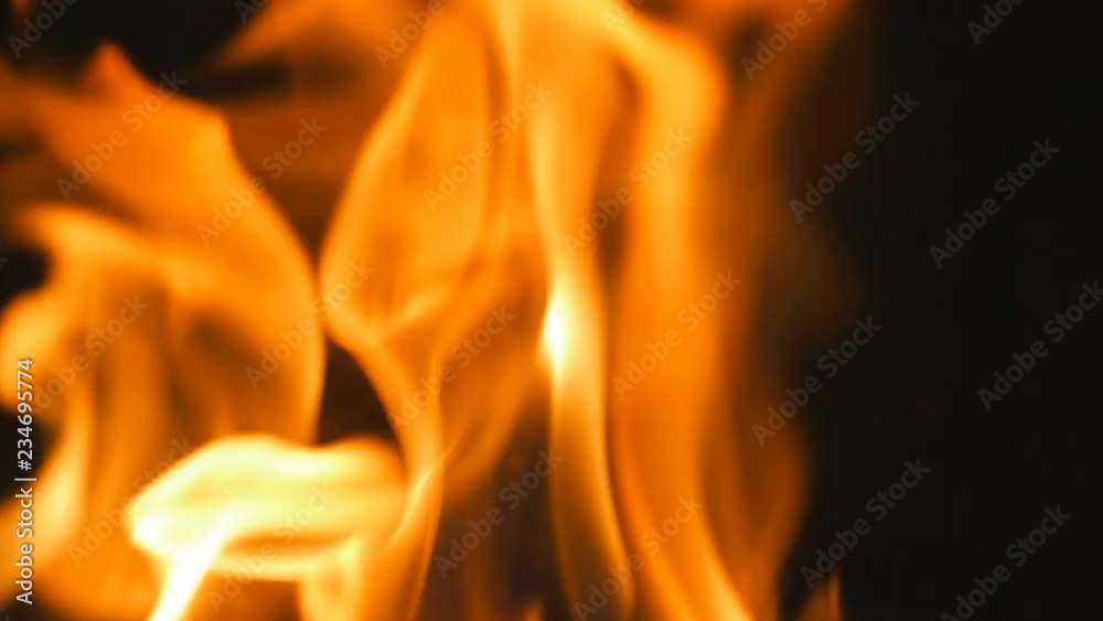 Slow motion yellow and orange flames. Closeup inside woodstove. Slow motion yellow and orange flames. Closeup inside woodstove.