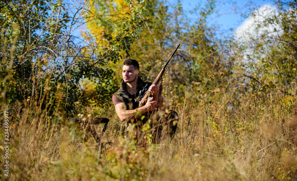 Hunting strategy or method for locating targeting and killing targeted animal. Hunting skills and strategy. Hunter with rifle ready to hunting nature background. Man hunting wait for animal Hunting strategy or method for locating targeting and killing targeted animal. Hunting skills and strategy. Hunter with rifle ready to hunting nature background. Man hunting wait for animal