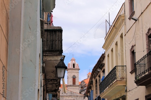 Looking down a street along the tops of buildings to the Havana Cathedral, Havana, Cuba.