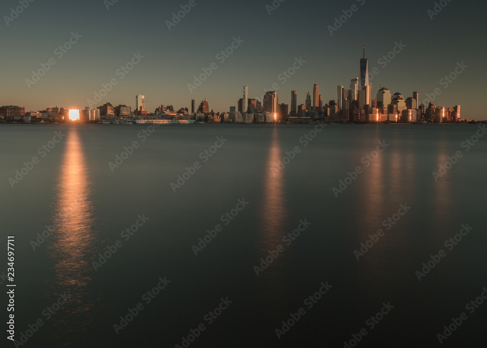 View on fiance district in Manhattan from Hudson river at sunset with sun  reflection 