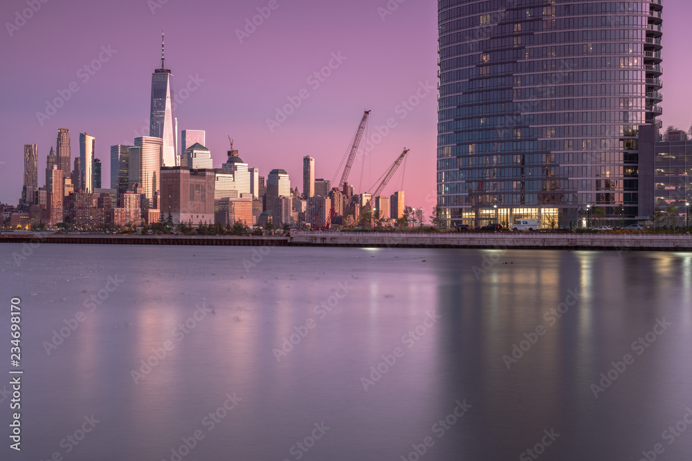 View on finance district Manhattan and Jersey city skyscrapers at sunset from Hudson river