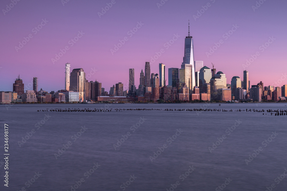 View on finance district in Manhattan at sunset from Hudson river View on finance district in Manhattan at sunset from Hudson river