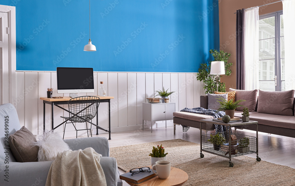 Fototapeta premium Grey sofa and blue armchair in living room with lamp blue white wall.