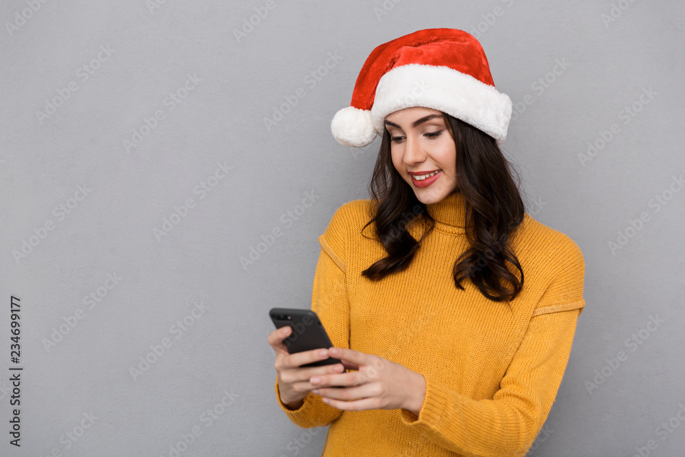 Portrait of a smiling woman wearing red santa claus hat Portrait of a smiling woman wearing red santa claus hat