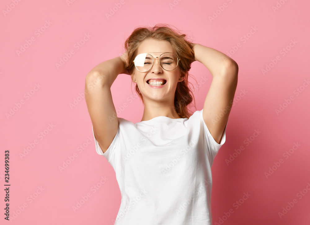 woman in white t-shirt and modern glasses posing shouting yelling with hands up on pink woman in white t-shirt and modern glasses posing shouting yelling with hands up on pink