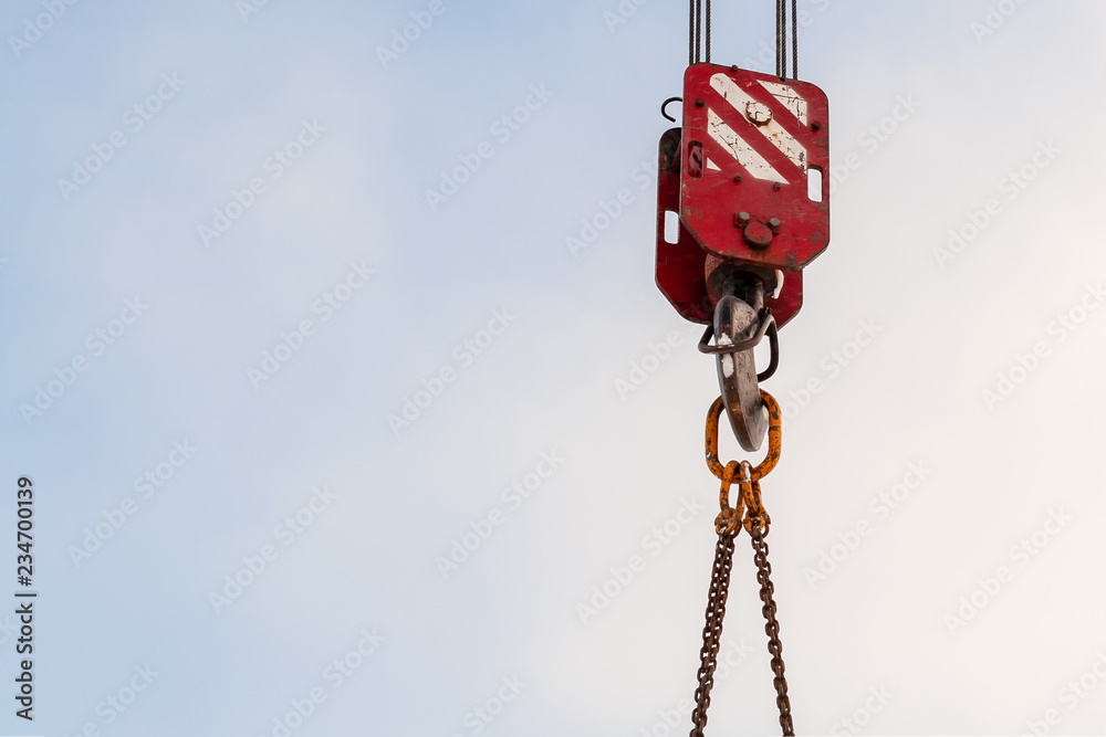 Hook of a construction crane against a blue sky Hook of a construction crane against a blue sky