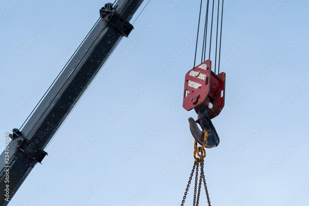 Hook of a construction crane against a blue sky. Hook of a construction crane against a blue sky.