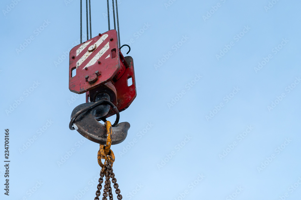 Hook of a construction crane against a blue sky Hook of a construction crane against a blue sky