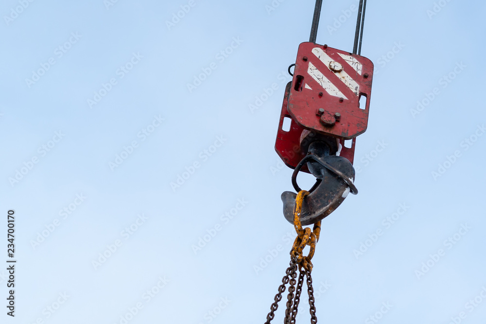 Hook of a construction crane against a blue sky Hook of a construction crane against a blue sky