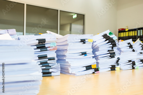 Pile of unfinished documents on office desk. photo