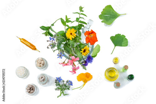 Organic medical pills with herbal plant in motar on white background. ethnoscience concept. top view photo