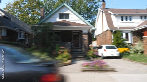 Driving past houses on suburban street in late summer. East York, Toronto, Ontario, Canada. photo
