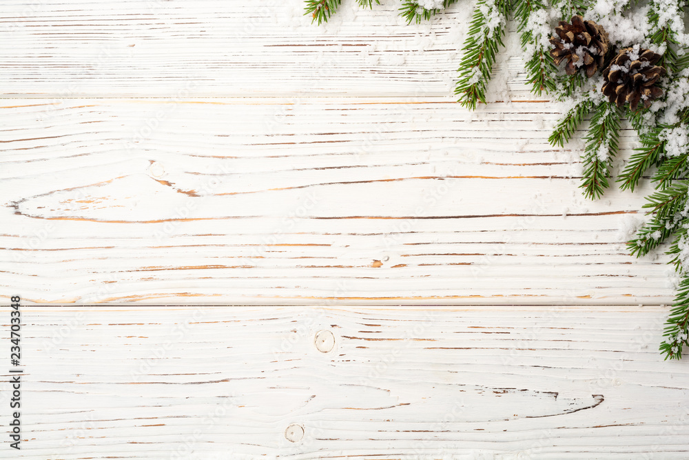 Christmas wooden background with fir branches, pine cones and snow. Top view with copy space. Christmas wooden background with fir branches, pine cones and snow. Top view with copy space.