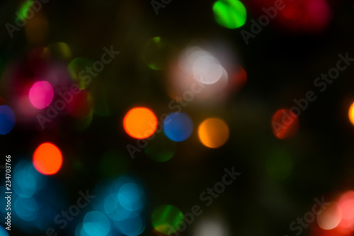 Bokeh. Christmas tree lights. Holiday background. Garland. Glitter. Christmas eve. Defocused sparkles. New Year backdrop. Blinks. Carnival. Bokeh retro style photo.